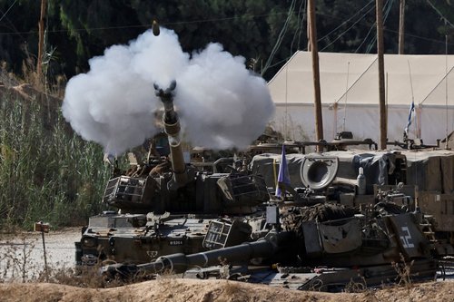 An Israeli mobile artillery unit fires towards Gaza near the Israel-Gaza border, in Israel