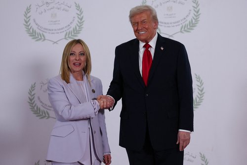 U.S. President Donald Trump and Italian Prime Minister Giorgia Meloni shake hands as they pose for a photo, at a world leaders' summit on ending the Gaza war