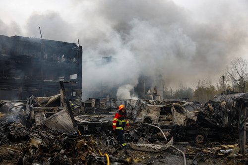 A firefighter walks at the site of food warehouses hit by an overnight Russian missile strike, amid Russia’s attack on Ukraine, in Kyiv, Ukraine October 25, 2025. REUTERS/Valentyn Ogirenko