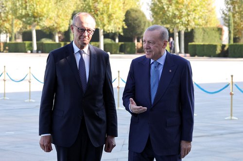Turkish President Tayyip Erdogan and German Chancellor Friedrich Merz attend a welcoming ceremony at the Presidential Palace in Ankara