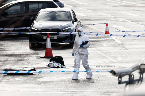 A forensic officer walks past a police cordon near Huntingdon Station, following a series of stabbings on a London North Eastern Railway (LNER) train, near Cambridge, Britain, November 2, 2025. REUTERS/Jack Taylor
