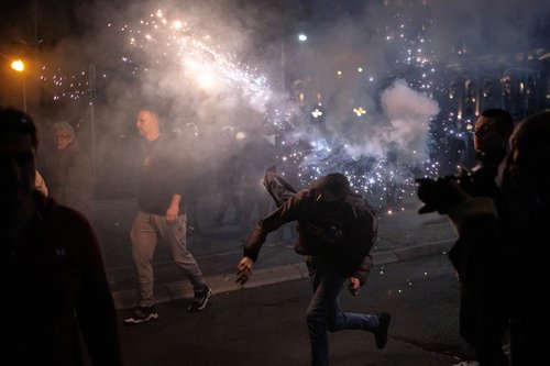 An anti-government demonstrator throws a flare during a protest near the parliament building in Belgrade, Serbia, November 2, 2025. REUTERS/Marko Djurica