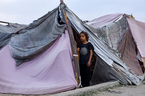 A displaced Palestinian girl looks out of a tent amid a ceasefire between Israel and Hamas, in Gaza City, November 4, 2025. TPX IMAGES OF THE DAY