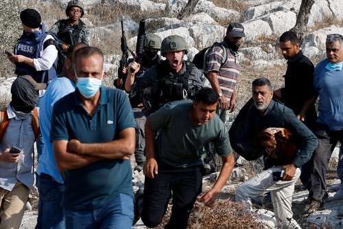 An Israeli soldier shouts at Palestinian protesters who went out to pray on their land, threatened by Israeli settlement expansion, in Beit Lid, near Tulkarm, in the Israeli-occupied West Bank, November 7, 2025.