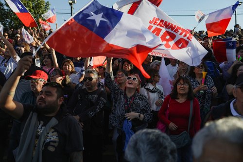 Supporters of Jeannette Jara, presidential candidate of the ruling leftist coalition and member of the Communist Party, wave Chilean flags as they attend one of Jara's last closing campaign rallies