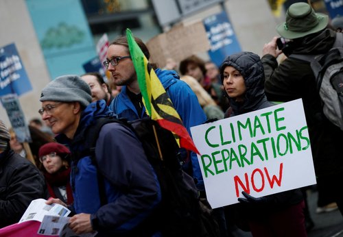 Demonstrators carry placards as people take part in a nationwide protest calling for stronger global climate actions, during the ongoing U.N. Climate Change Conference (COP30) in Brazil, in Manchester, Britain, November 15, 2025.