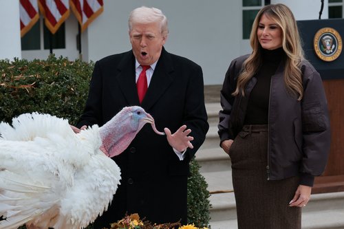 U.S. President Donald Trump and U.S. first lady Melania Trump react next to Gobble, one of two turkeys ceremonially pardoned for Thanksgiving, in the Rose Garden at the White House in Washington, D.C., U.S., November 25, 2025. REUTERS/Jonathan Ernst