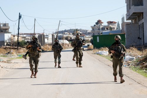 Israeli soldiers walk as they take part in an operation in Tubas, in the Israeli-occupied West Bank, November 26, 2025. REUTERS/Mohamad Torokman