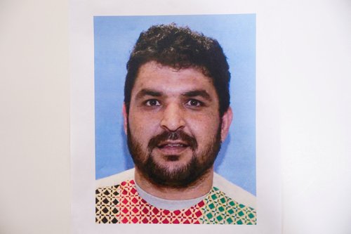 A picture of Rahmanullah Lakanwal, an Afghan national who is the suspect in the shooting of two National Guard members, is displayed at a press conference with FBI Director Kash Patel, attorney Jeanine Pirro and other authorities