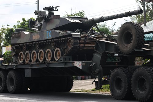 A military truck carries a tank on a road amid deadly clashes between Thailand and Cambodia along a disputed border area, in Surin province, Thailand, December 11, 2025. REUTERS/Athit Perawongmetha