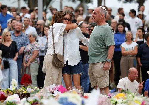 People pay respects at Bondi Pavilion to victims of a shooting during a Jewish holiday celebration at Bondi Beach, in Sydney, Australia, December 15, 2025.