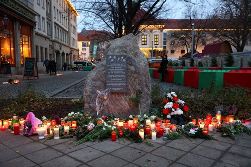 Flowers and candles are left at a memorial for the victims of last year's attack on the Magdeburg Christmas market