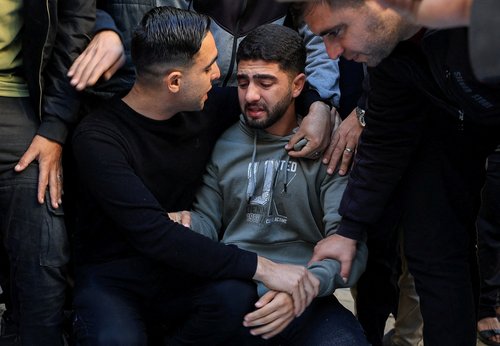 Mohamed Al-Nather mourns his father and his 4-month-old brother Ahmed during the funeral of Palestinians killed in an Israeli strike on Friday,