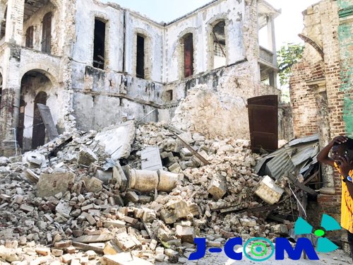 Bricks and debris are seen in front of a house that collapsed following an earthquake in Jeremie