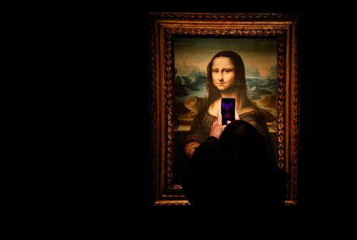 FILE PHOTO: A visitor takes a photo of a copy of the Leonardo da Vinci's Mona Lisa, which will go up for auction on November 9, at the Artcurial auction house in Paris