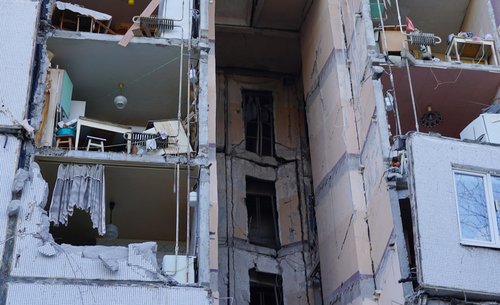 A view shows a damaged residential building in Kharkiv