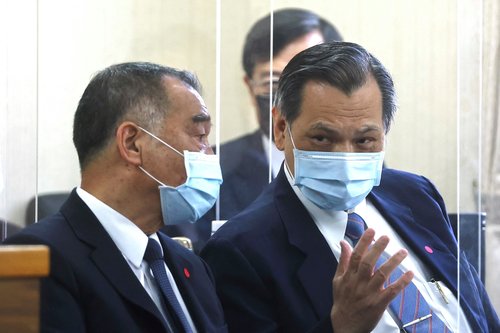 Taiwan's Defence Minister Chiu Kuo-cheng and Director-General of National Security Bureau Chen Ming-tong share a conversation at the parliament in Taipei