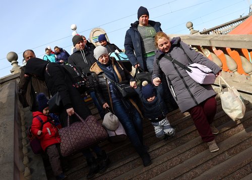 Refugees from the ongoing Russian invasion arrive at a train station in Lviv
