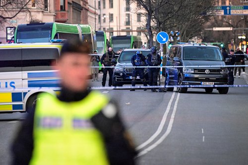 Police officers gather at the scene of a crime by a school in Malmo