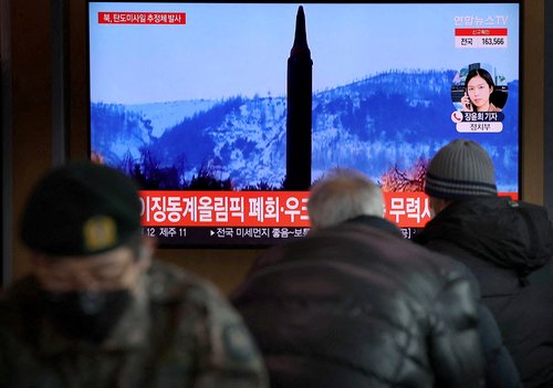 FILE PHOTO: FILE PHOTO: People watch a TV broadcasting file footage of a news report on North Korea firing what appeared to be a ballistic missile, in Seoul