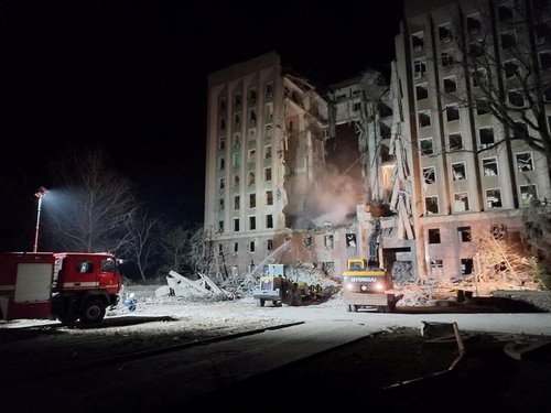 Rescuers work at the site of the regional administration building hit by cruise missiles, in Mykolaiv