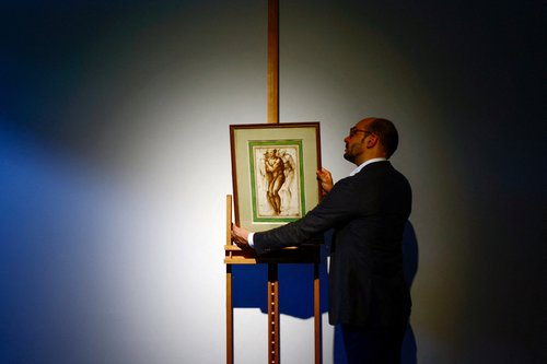The drawing "A nude young man (after Masaccio) surrounded by two figures" by Michelangelo on display before its auction in Paris