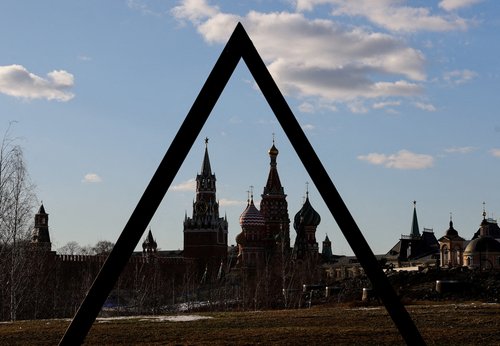 FILE PHOTO: The Kremlin's Spasskaya Tower and St. Basil's Cathedral are seen through the art object in Zaryadye park in Moscow