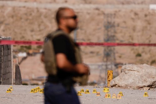 Evidence markers are seen at a crime scene where unknown assailants murdered a ministerial police officer and his wife in Ciudad Juarez