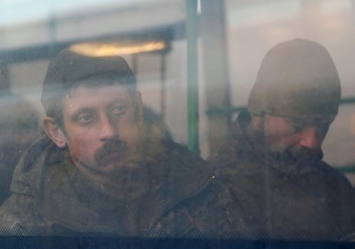 Buses carrying service members of Ukrainian forces who have surrendered after weeks holed up at Azovstal steel works arrive in Olenivka