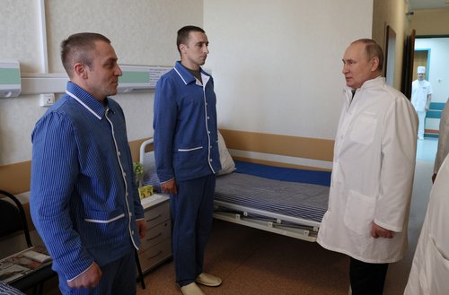 Russian President Vladimir Putin visits soldiers wounded during the conflict in Ukraine at a hospital in Moscow