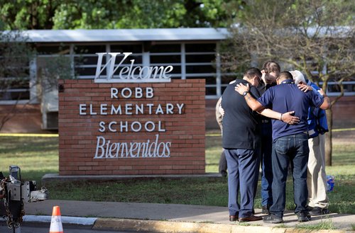 People react after a mass shooting at Robb Elementary School in Uvalde