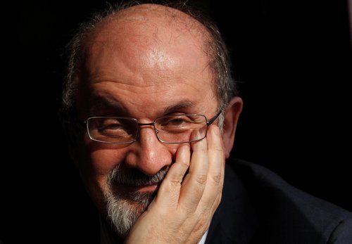 FILE PHOTO: Author Salman Rushdie poses for a photograph after an interview with Reuters in central London