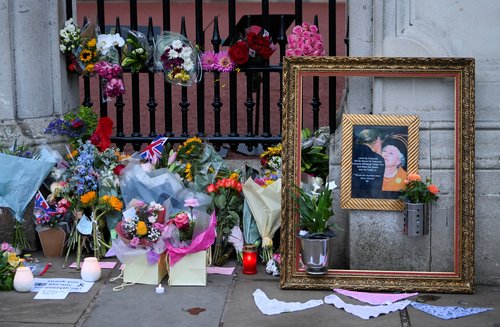 Tributes are placed at Buckingham Palace, following the passing of Queen Elizabeth, in London