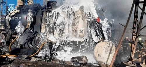 FILE PHOTO: Firefighters work to put out a fire in a thermal power plant, damaged by a Russian missile strike in Zhytomyr