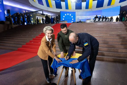 Ukraine's President Zelenskiy, Prime Minister Shmyhal and European Commission President von der Leyen sign a Ukrainian national flag before start of EU summit in Kyiv