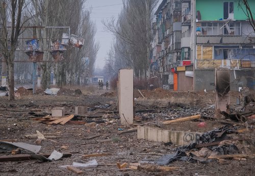 Ukrainian service members are seen an empty street in Bakhmut