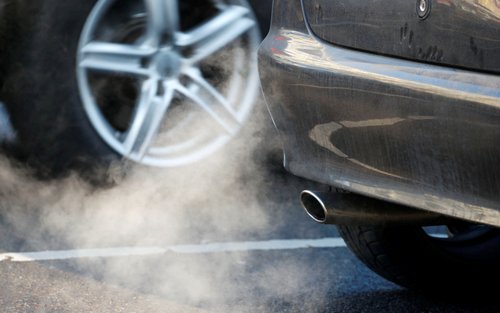 FILE PHOTO: An exhaust pipe of a car is pictured on a street in a Berlin