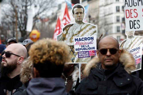 FILE PHOTO: French unions and workers march against pension reforms in Paris