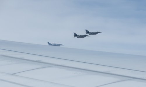 Taiwan Air Force F-16 fighter jets fly near the airplane transporting Taiwan’s President Tsai Ing-wen during her trip to Guatemala and Belize, stopping in New York