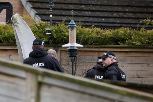 Police officers stand outside the house of former SNP Chief Executive Peter Murrell, in Glasgow