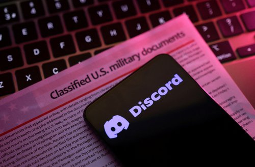 A mockup representation of classified U.S. military documents and the Discord logo are seen in this illustration