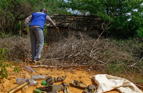Francis Auma, a human rights activist, walks towards the home of a suspected follower of a Christian cult in Kilifi