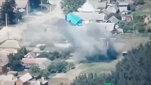 A still image from a drone footage released by Freedom of Russia Legion shows what they claim is a destruction of Russian military targets near Novaya Tavolzhanka