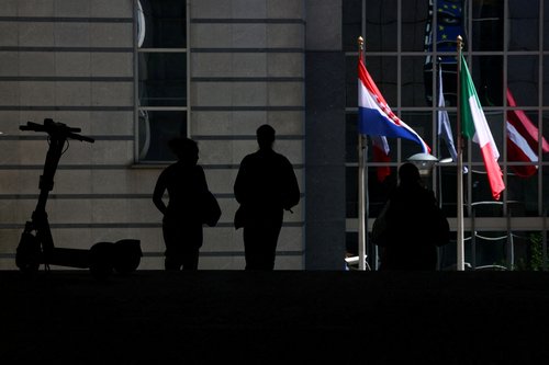 FILE PHOTO: People walk near the entrance of the European Parliament in Brussels