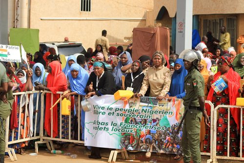 Nigerien women demonstrate by hitting and carrying kitchen utensils in support of the putschists in front of French Army headquarters, in Niamey