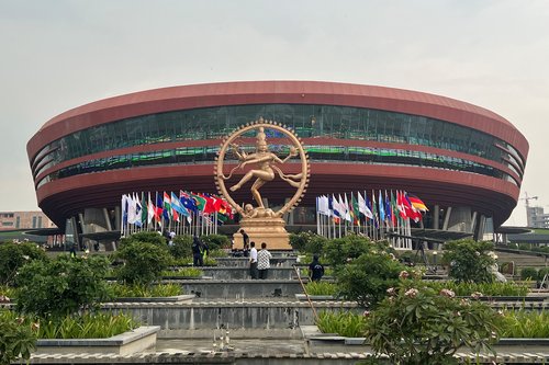 People stand infront of Nataraja installed next to 'Bharat Mandapam' in New Delhi
