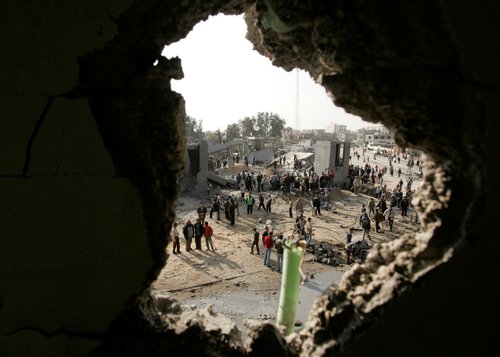 FILE PHOTO: Palestinians inspect Badr mosque after it was bombed by Israeli military aircraft in the southern Gaza Strip