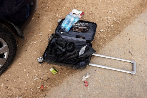 Ammunition and bullet shells are seen near someone's personal belongings in an abandoned carpark near where a festival was held before an attack by Hamas gunmen from Gaza that left at least 260 people dead, by Israel's border with Gaza in southern Israel