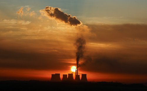 FILE PHOTO: Sun rises behind the cooling towers of Kendal Power Station