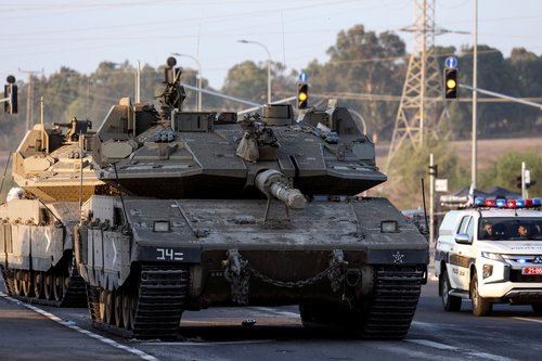 Israeli tanks seen on a road near Israel's border with the Gaza Strip, in southern Israel